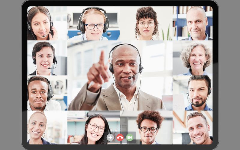 A number of people's faces clustered around a presenter's face on online software